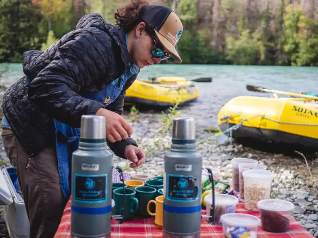 Preparing drinks during a break on a rafting trip